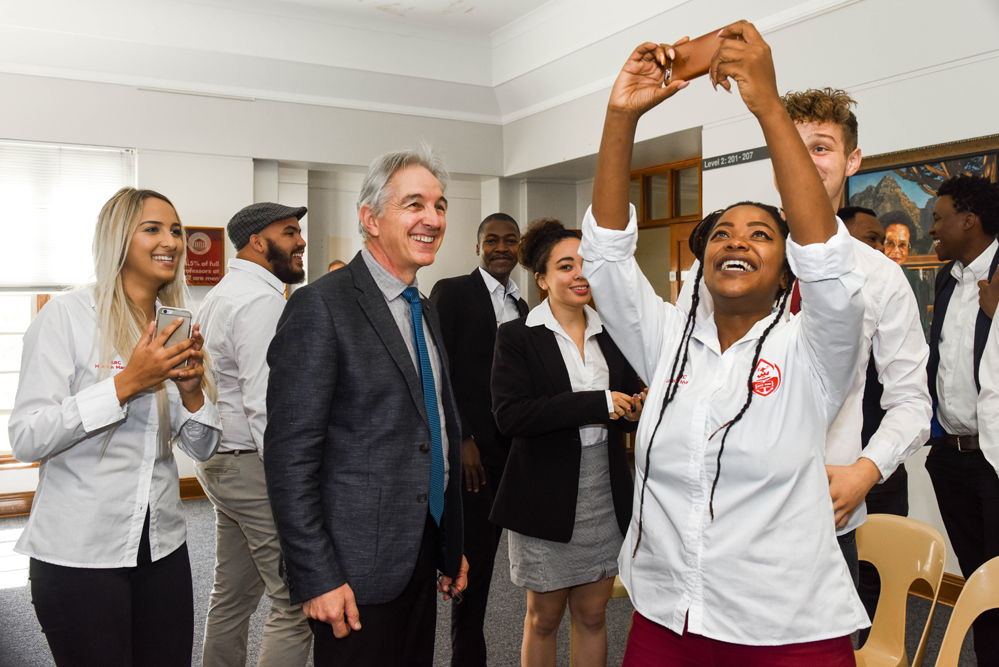 The 2017/2018 Students’ Representative Council takes some time out from their official portrait to take photos with Dr Price in the Bremner building in 2018.