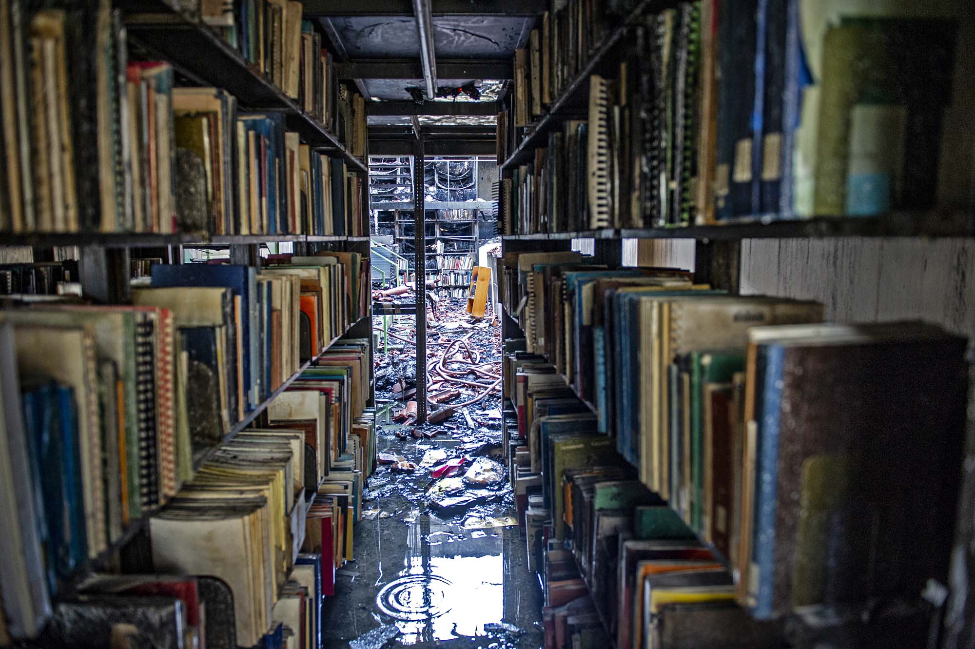 Books that were spared from the fire await their turn to be rescued.