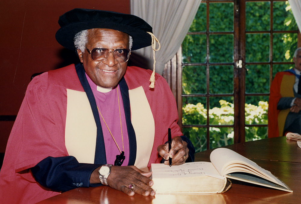 Archbishop Emeritus Desmond Tutu signs the register of honorary graduates prior to being conferred with the degree of Doctor of Laws (honoris causa) at UCT in 1993. Photo UCT Library Services Archives