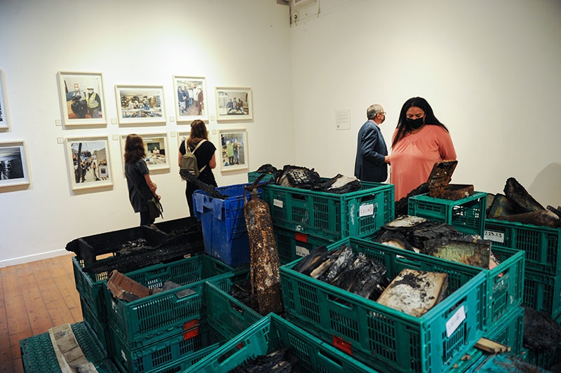 Crates of burnt remains include books, fire hydrants, roof tiles and wooden shelving.