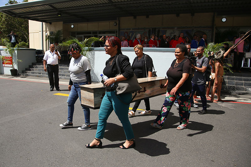 A coffin is carried out of UCT’s Anatomy Building to the hearse